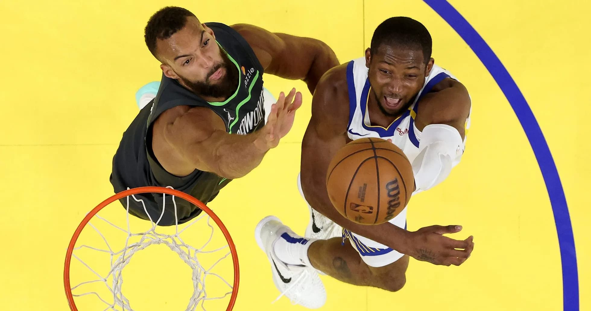 Player attempting a shot while being defended Player attempting a shot while being defended