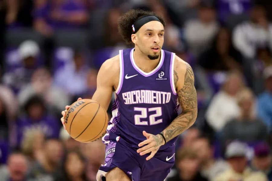 Player dribbling basketball during game for Sacramento Kings Player dribbling basketball during game for Sacramento Kings