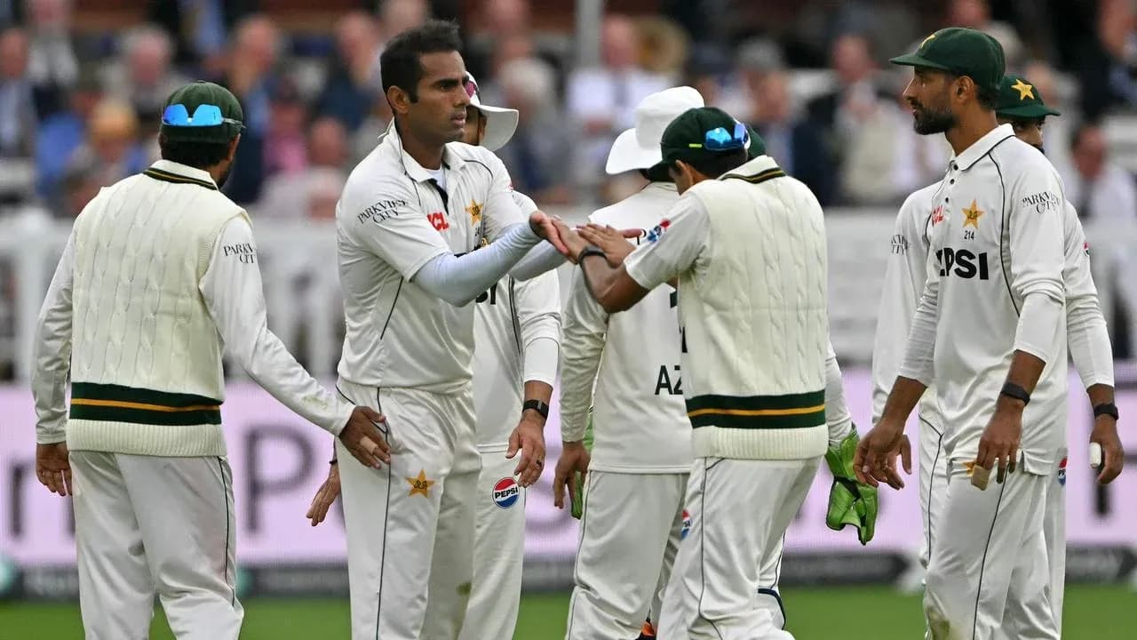 Pakistani cricketers celebrating a wicket on field Pakistani cricketers celebrating a wicket on field
