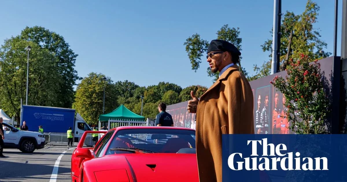 Person standing next to a red sports car outdoors Person standing next to a red sports car outdoors