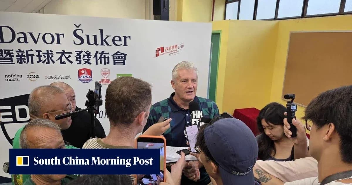 Davor Šuker speaking at a press event surrounded by media Davor Šuker speaking at a press event surrounded by media