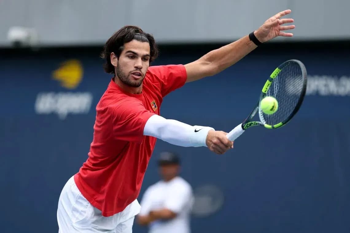 Tennis player hitting a forehand during practice Tennis player hitting a forehand during practice