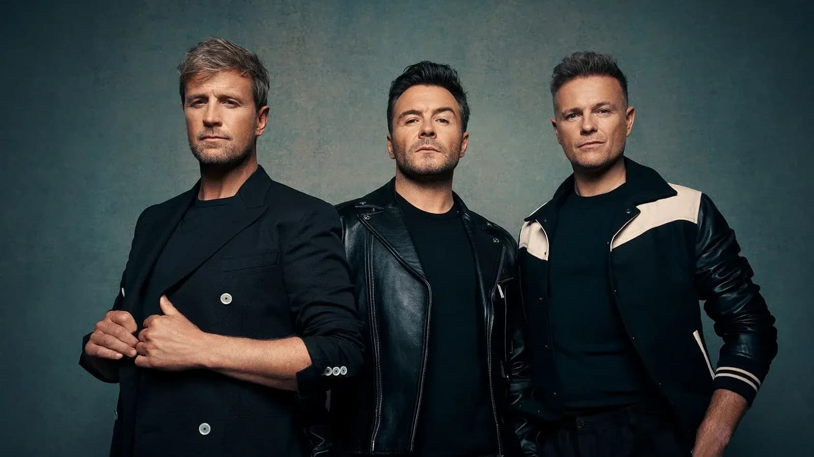 Three male singers posing against a neutral background Three male singers posing against a neutral background