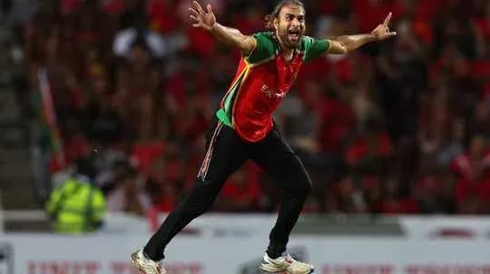 Player celebrating a wicket during a cricket match Player celebrating a wicket during a cricket match