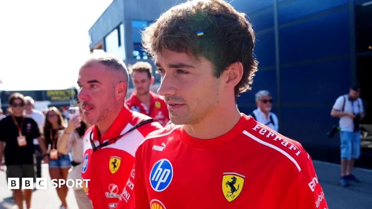 Ferrari team members walking in paddock area Ferrari team members walking in paddock area