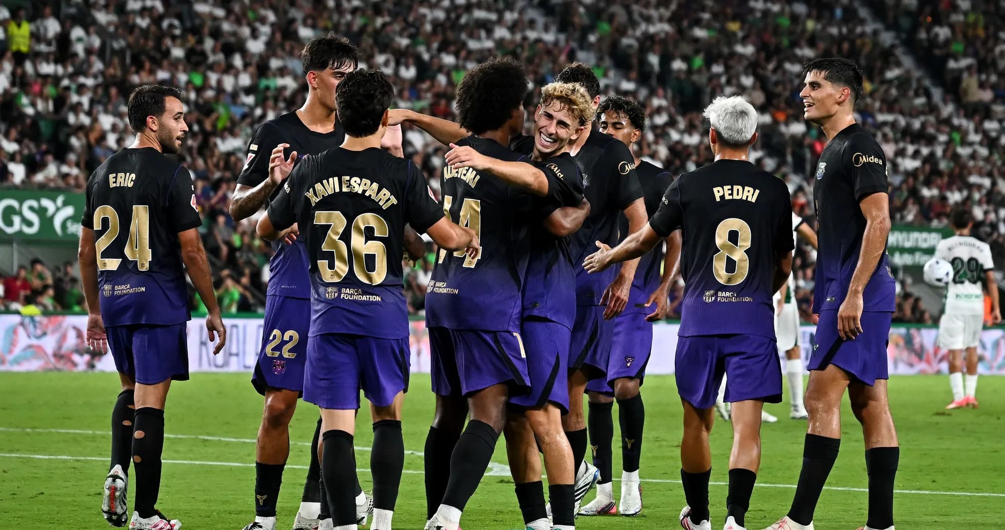 Players celebrating a goal during a football match Players celebrating a goal during a football match
