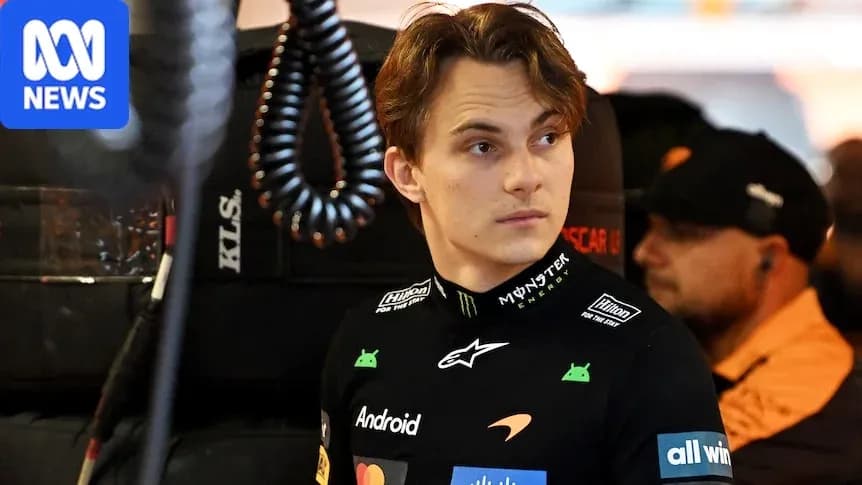 Driver in team uniform in garage area Driver in team uniform in garage area
