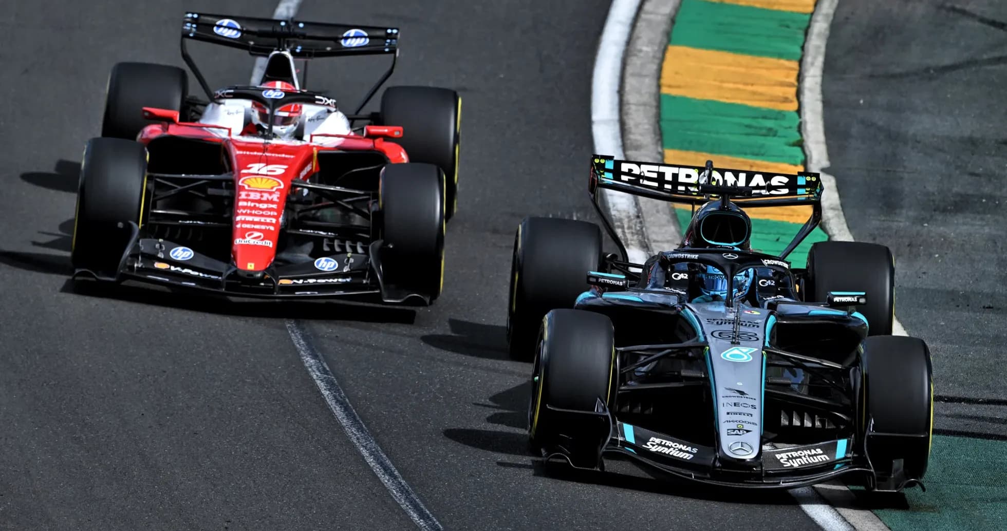 Two Formula 1 cars racing on track during event Two Formula 1 cars racing on track during event