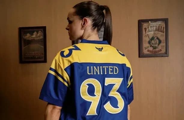 Person wearing a blue and yellow jersey with '93' and 'UNITED' Person wearing a blue and yellow jersey with '93' and 'UNITED'