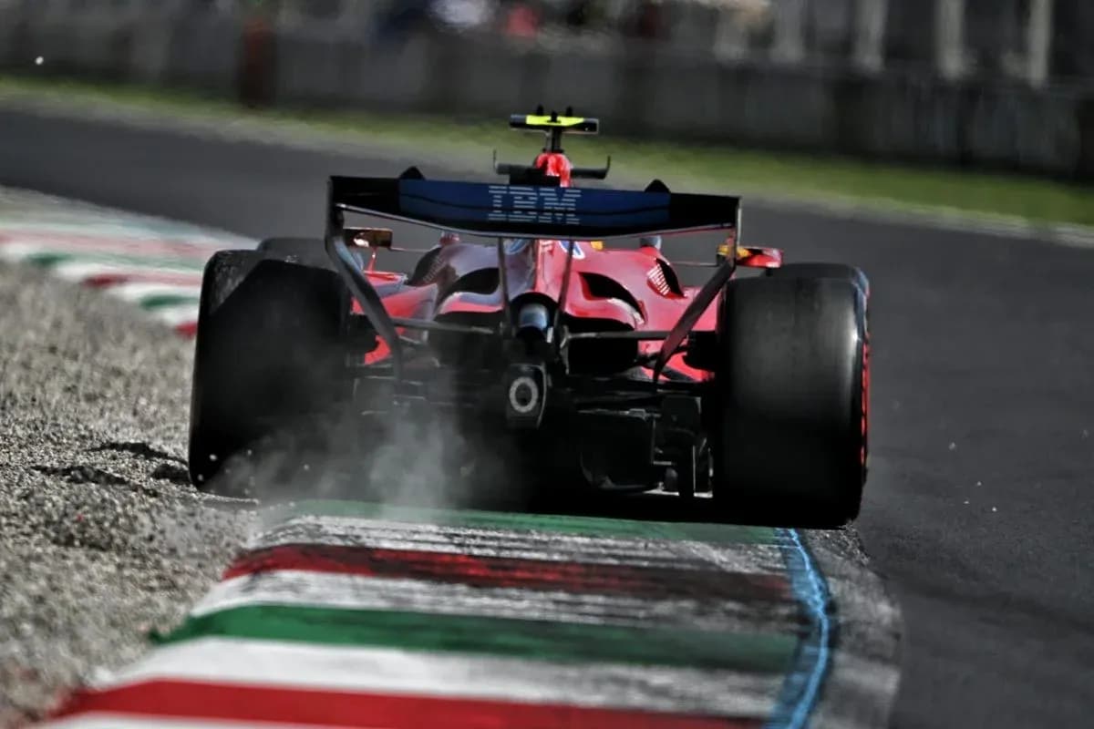 Red Formula 1 car driving on track with dust Red Formula 1 car driving on track with dust