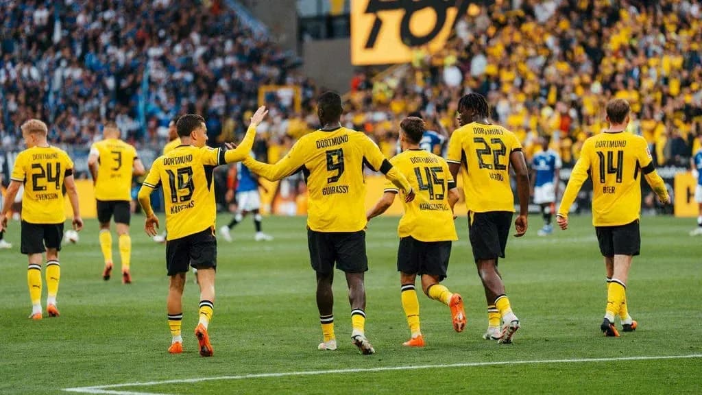Borussia Dortmund players celebrating during a match Borussia Dortmund players celebrating during a match