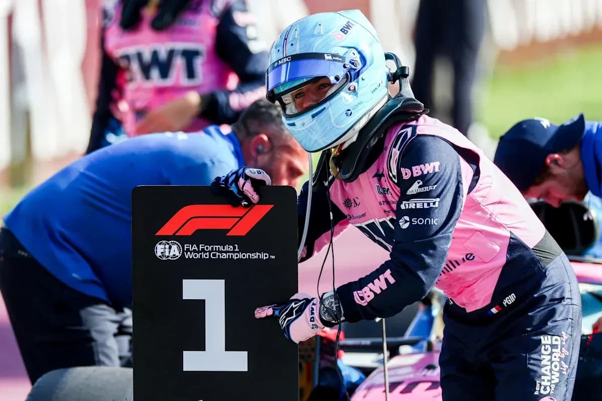 Driver holding '1' sign during Formula 1 event Driver holding '1' sign during Formula 1 event
