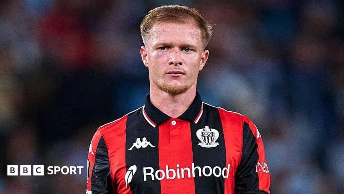 Player in red and black jersey during match Player in red and black jersey during match