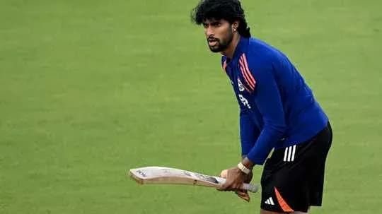 Cricketer practicing with bat on training field Cricketer practicing with bat on training field