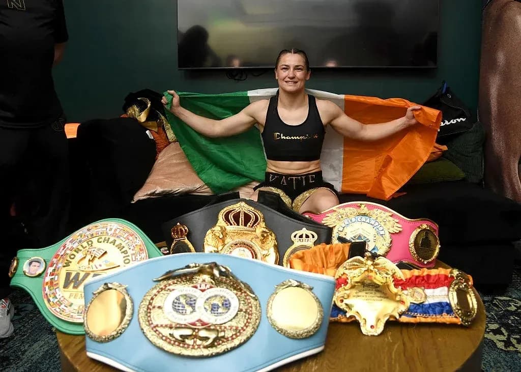 Boxer holding Irish flag with championship belts Boxer holding Irish flag with championship belts