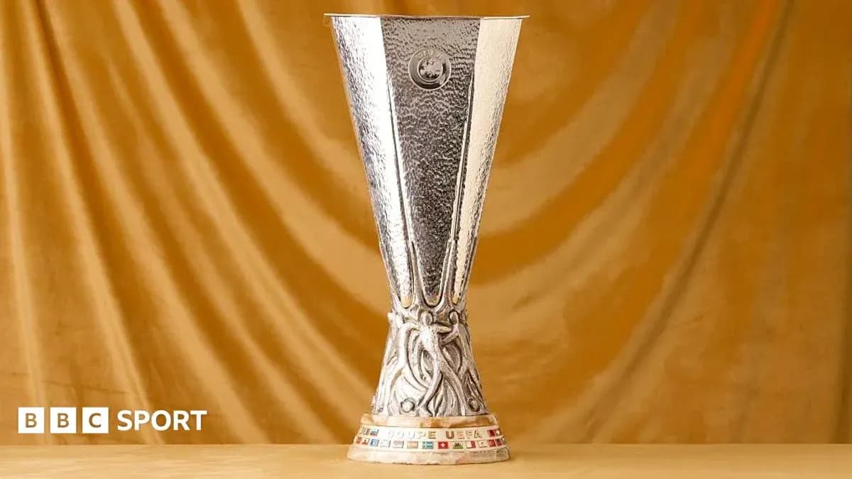 UEFA Cup trophy displayed on golden background UEFA Cup trophy displayed on golden background