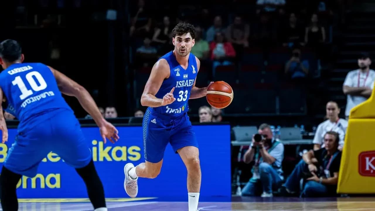 Player dribbling basketball during game action Player dribbling basketball during game action