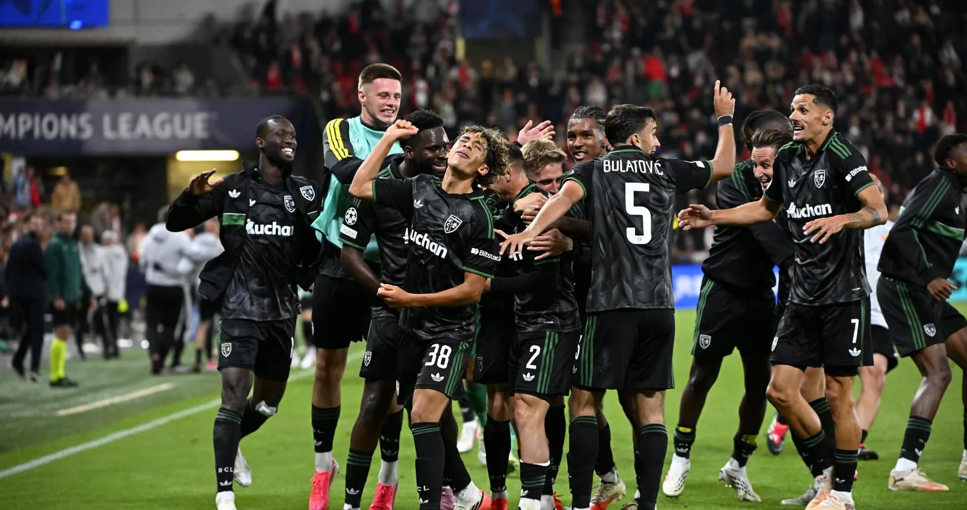 Players celebrating a goal during a Champions League match Players celebrating a goal during a Champions League match