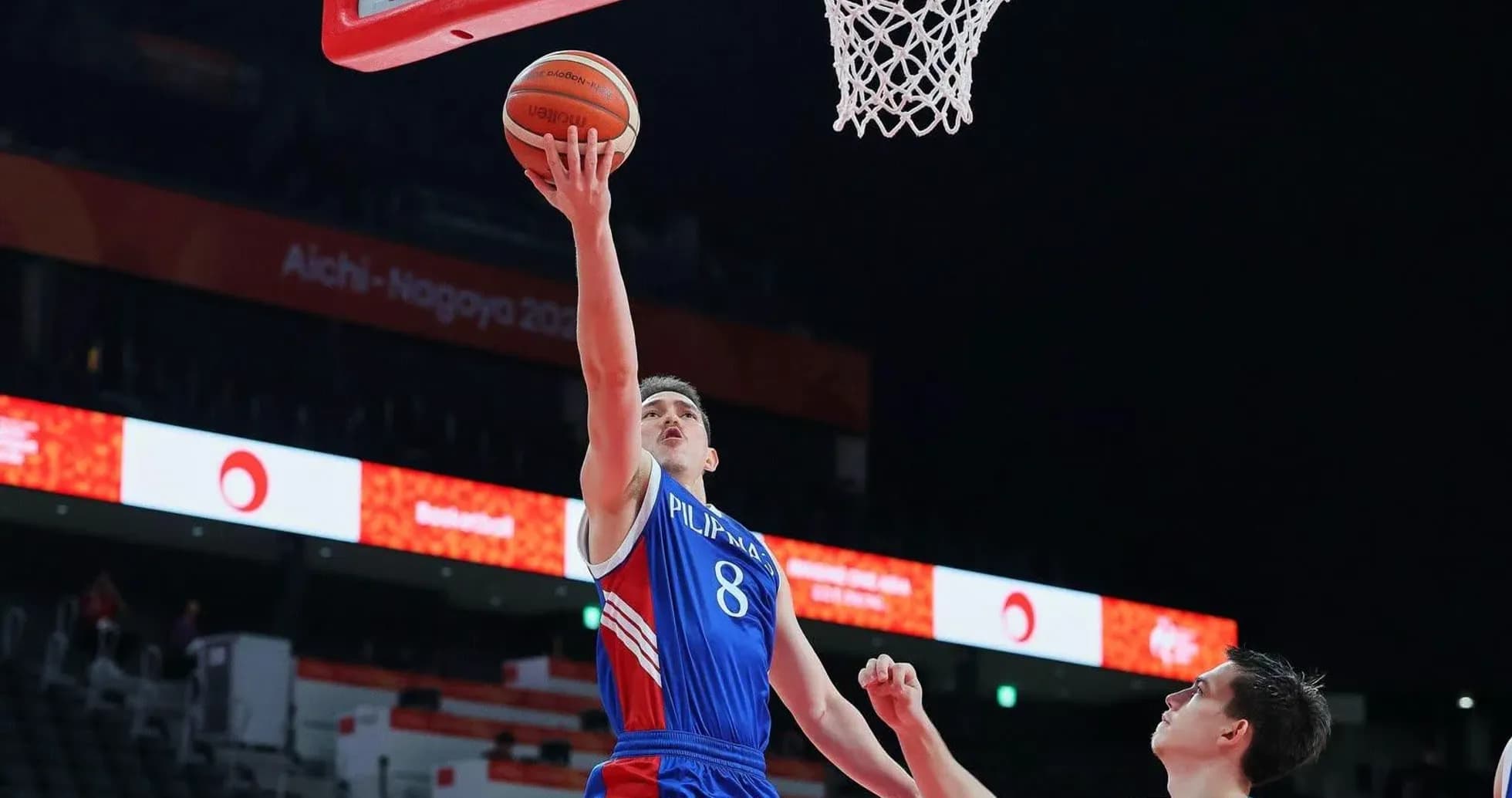 Player attempting a layup during basketball game Player attempting a layup during basketball game