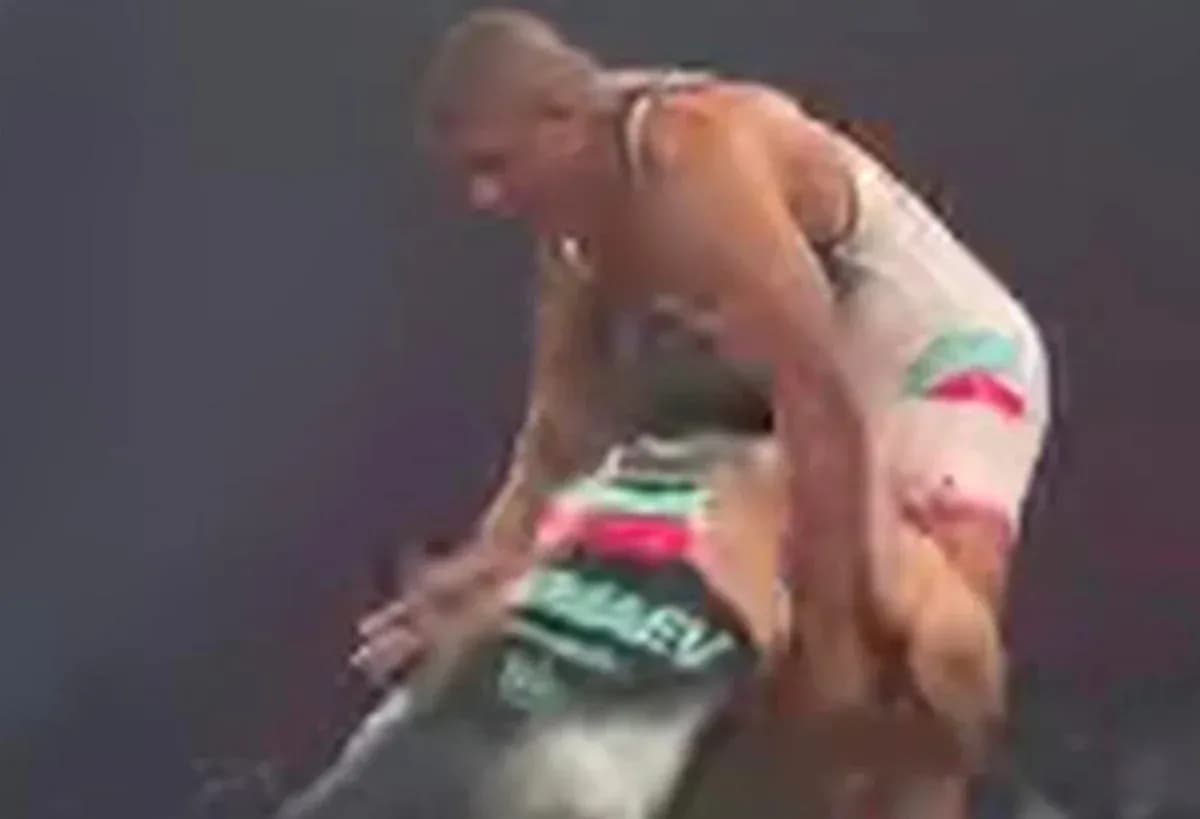 Two wrestlers competing in an intense match Two wrestlers competing in an intense match