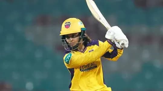 Batter playing a shot in yellow cricket uniform Batter playing a shot in yellow cricket uniform