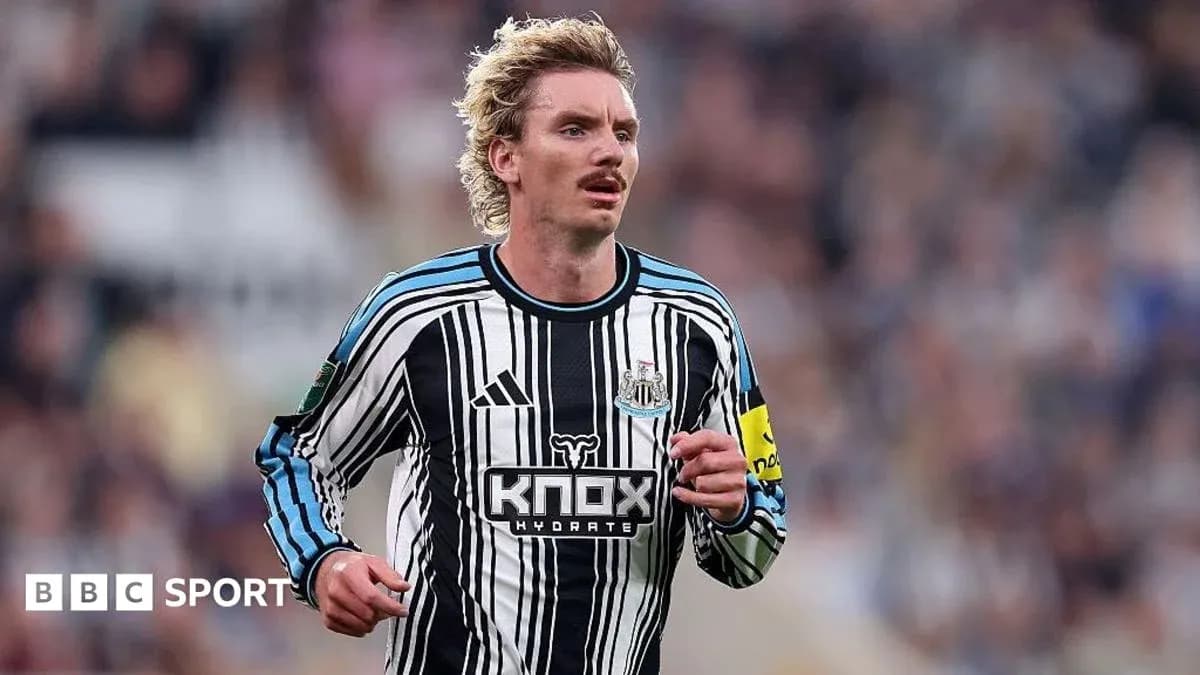 Player running on the field in Newcastle kit Player running on the field in Newcastle kit