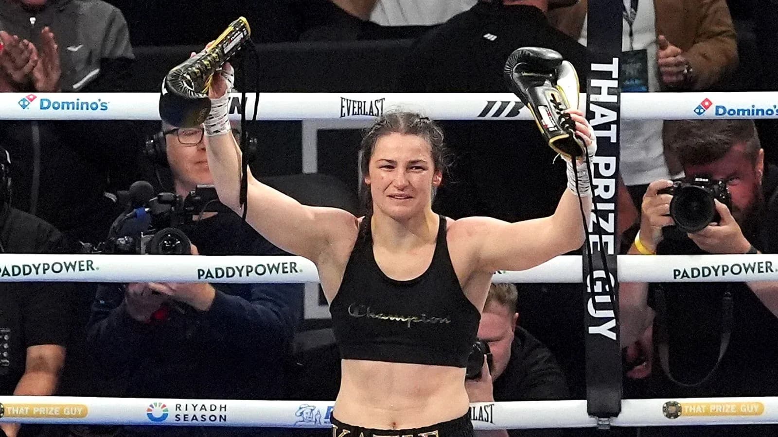 Boxer celebrating victory with gloves raised in ring Boxer celebrating victory with gloves raised in ring