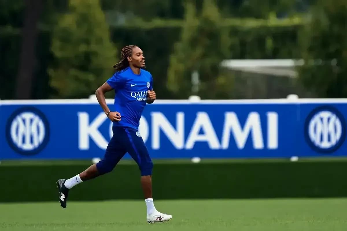 Player jogging on training pitch at practice session Player jogging on training pitch at practice session