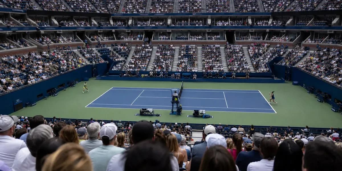 Tennis match in progress at a packed stadium Tennis match in progress at a packed stadium