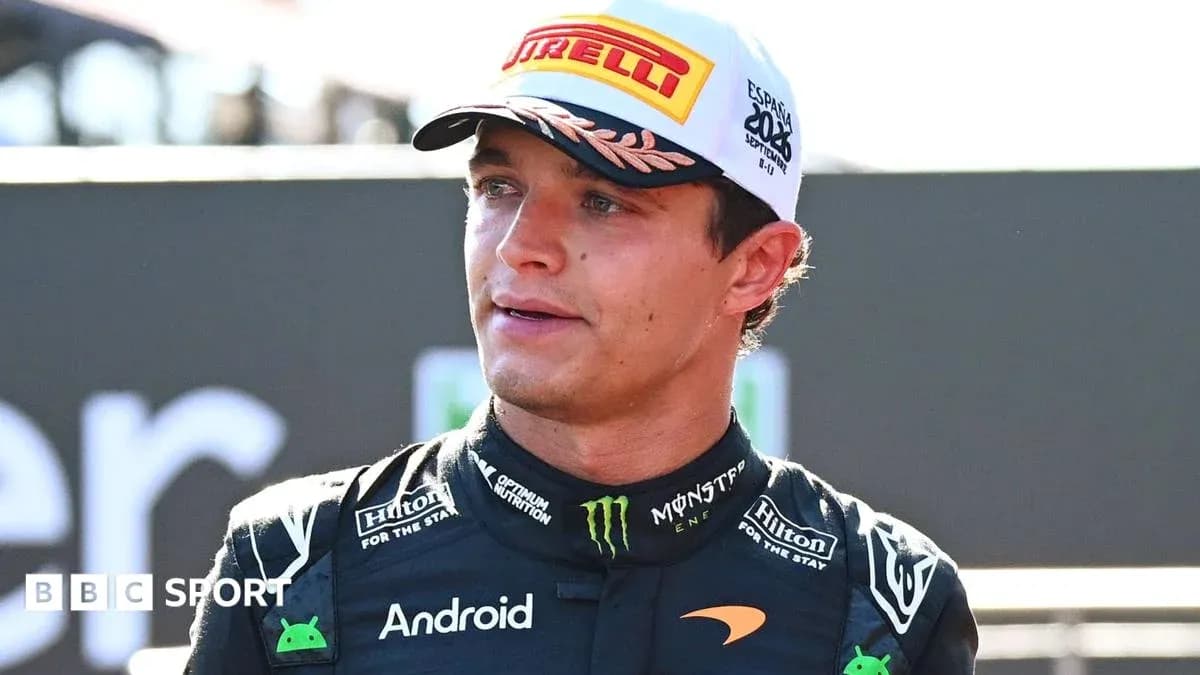 Driver wearing McLaren racing suit at event Driver wearing McLaren racing suit at event