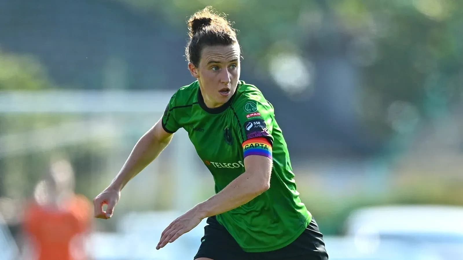 Player in green jersey running on the field Player in green jersey running on the field