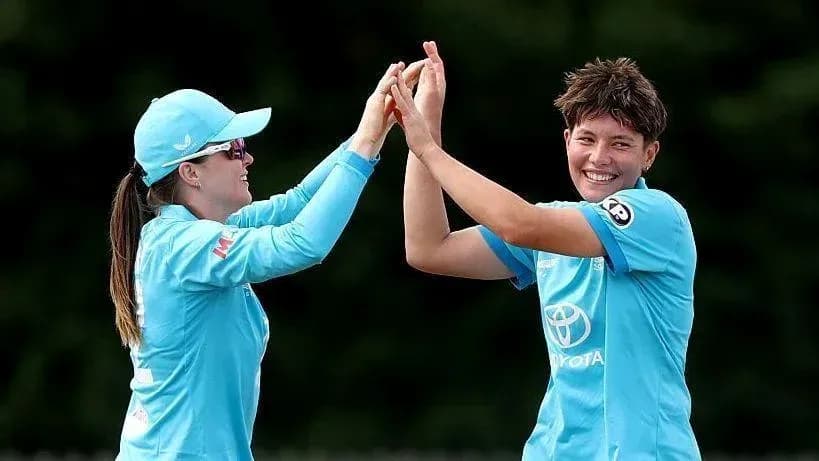 Two cricket players celebrating a successful play Two cricket players celebrating a successful play