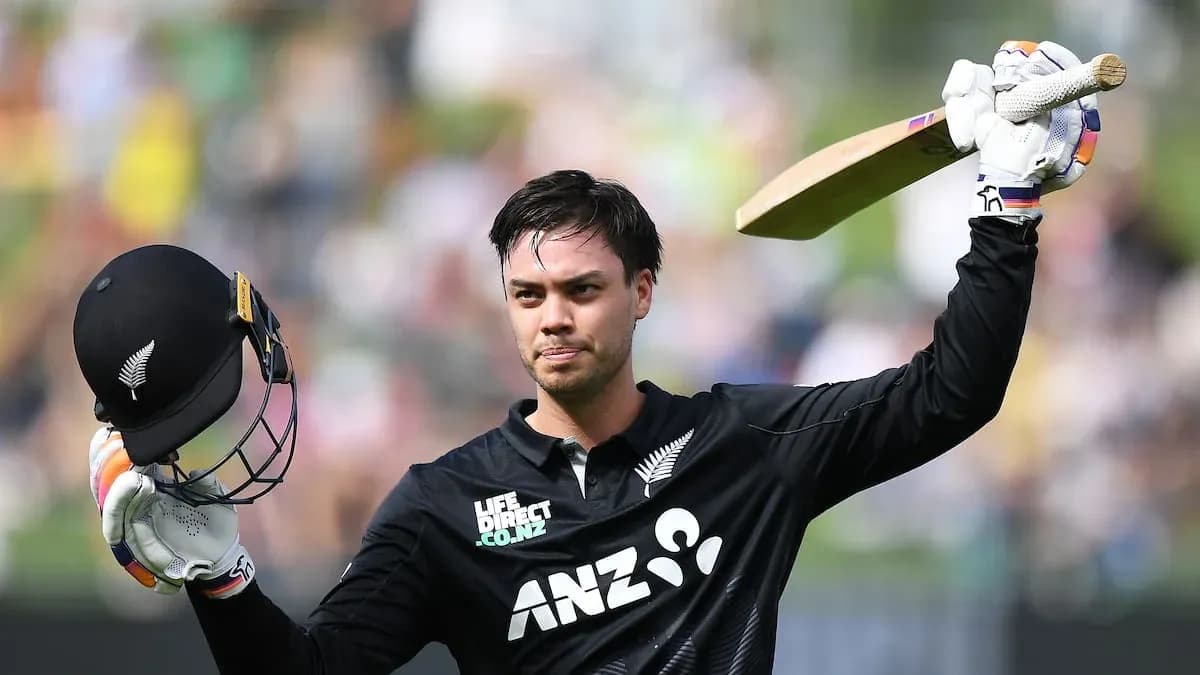 Cricketer celebrating a half-century with helmet raised Cricketer celebrating a half-century with helmet raised