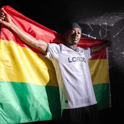 Player holding a flag with green, yellow, and red stripes Player holding a flag with green, yellow, and red stripes