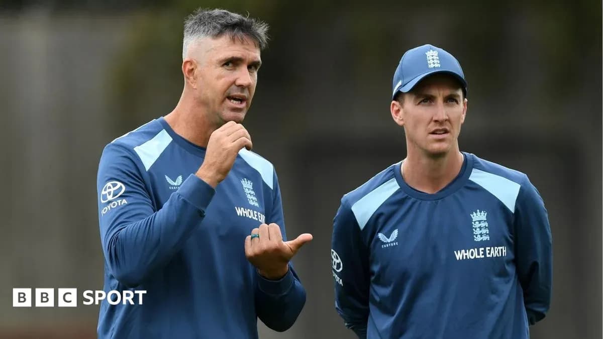 Two cricket coaches discussing during training session Two cricket coaches discussing during training session