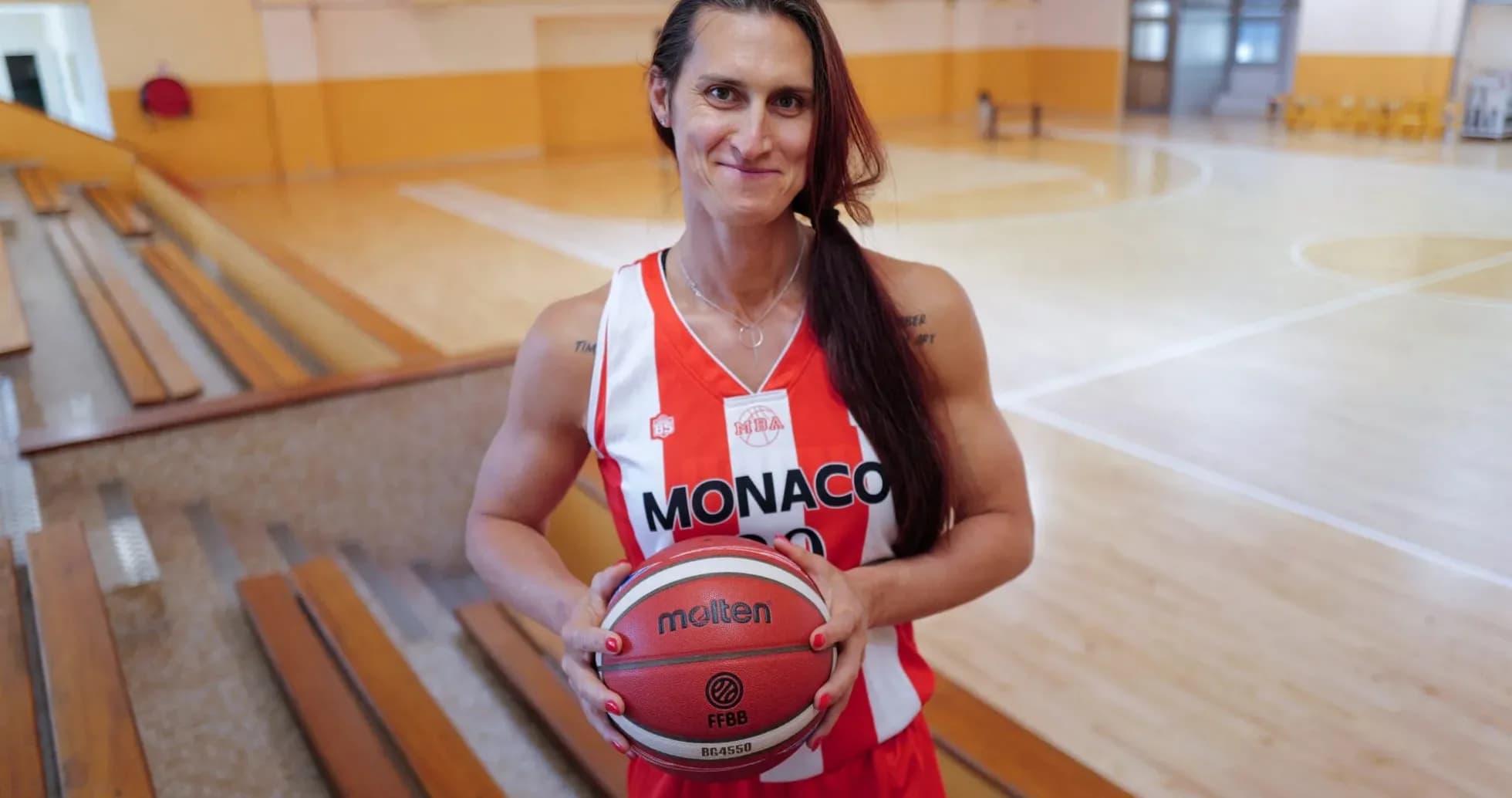 Player in Monaco jersey holding a basketball Player in Monaco jersey holding a basketball