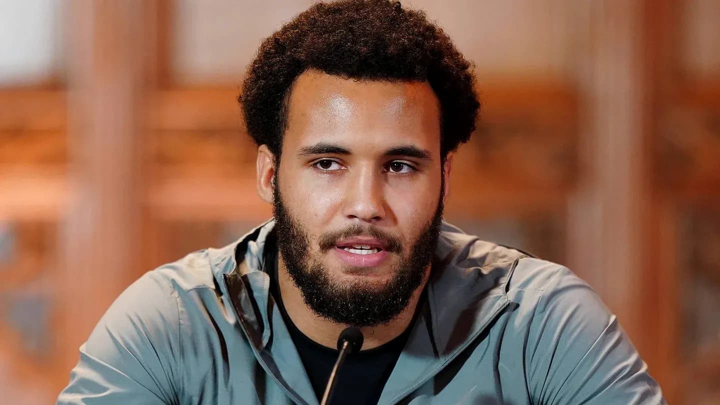 Athlete speaking at press conference with microphone Athlete speaking at press conference with microphone