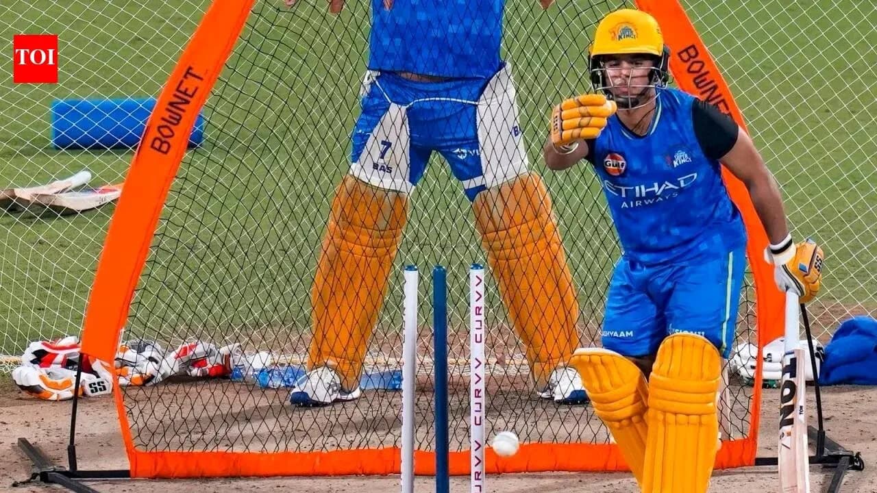 Batter practicing in nets with wicketkeeper behind Batter practicing in nets with wicketkeeper behind