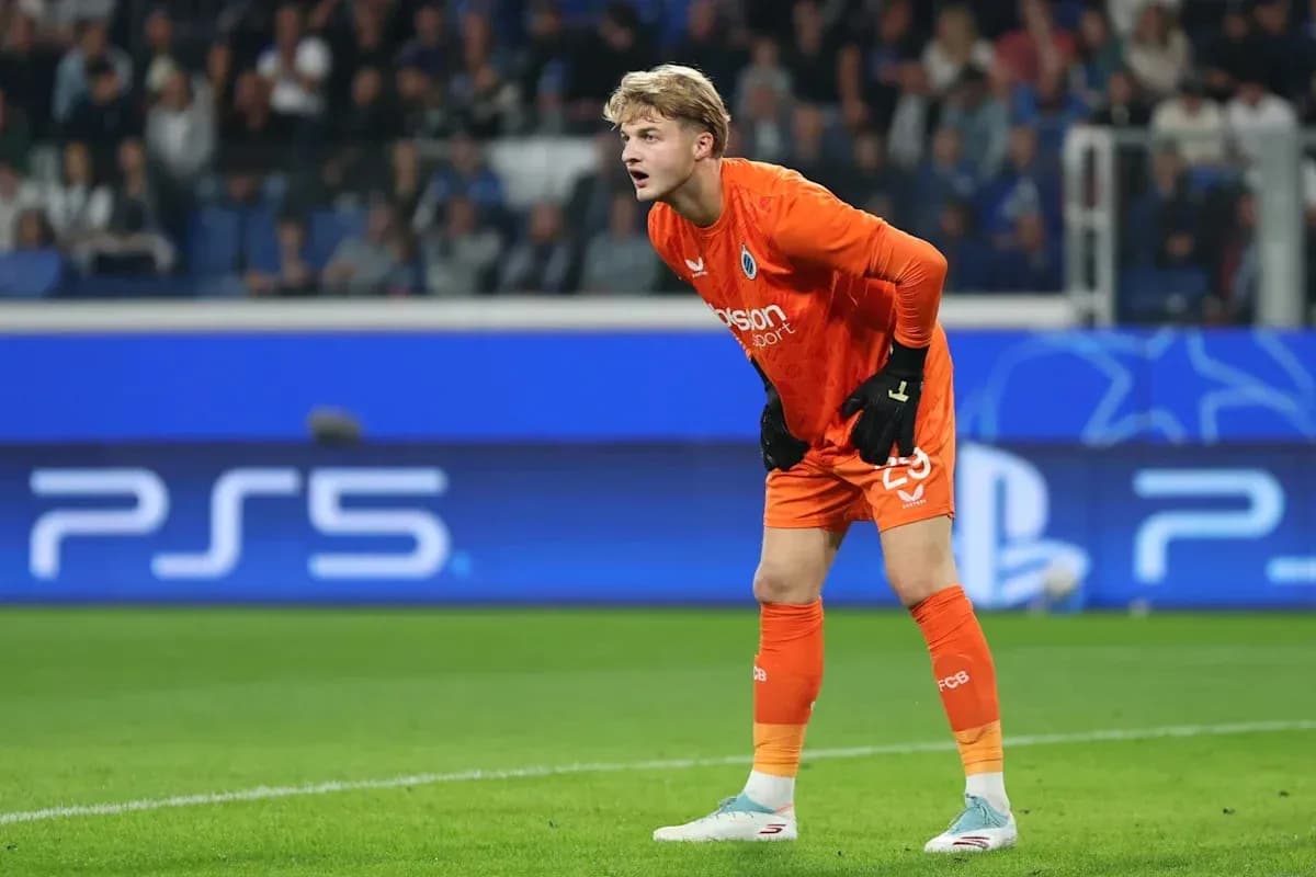 Goalkeeper in orange kit preparing for play Goalkeeper in orange kit preparing for play