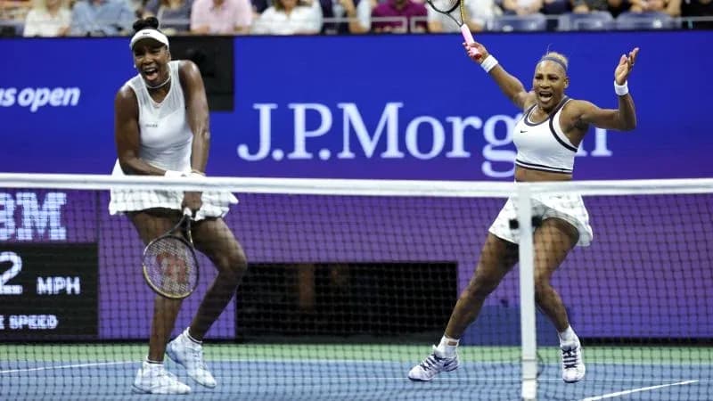 Venus and Serena Williams celebrating during match Venus and Serena Williams celebrating during match