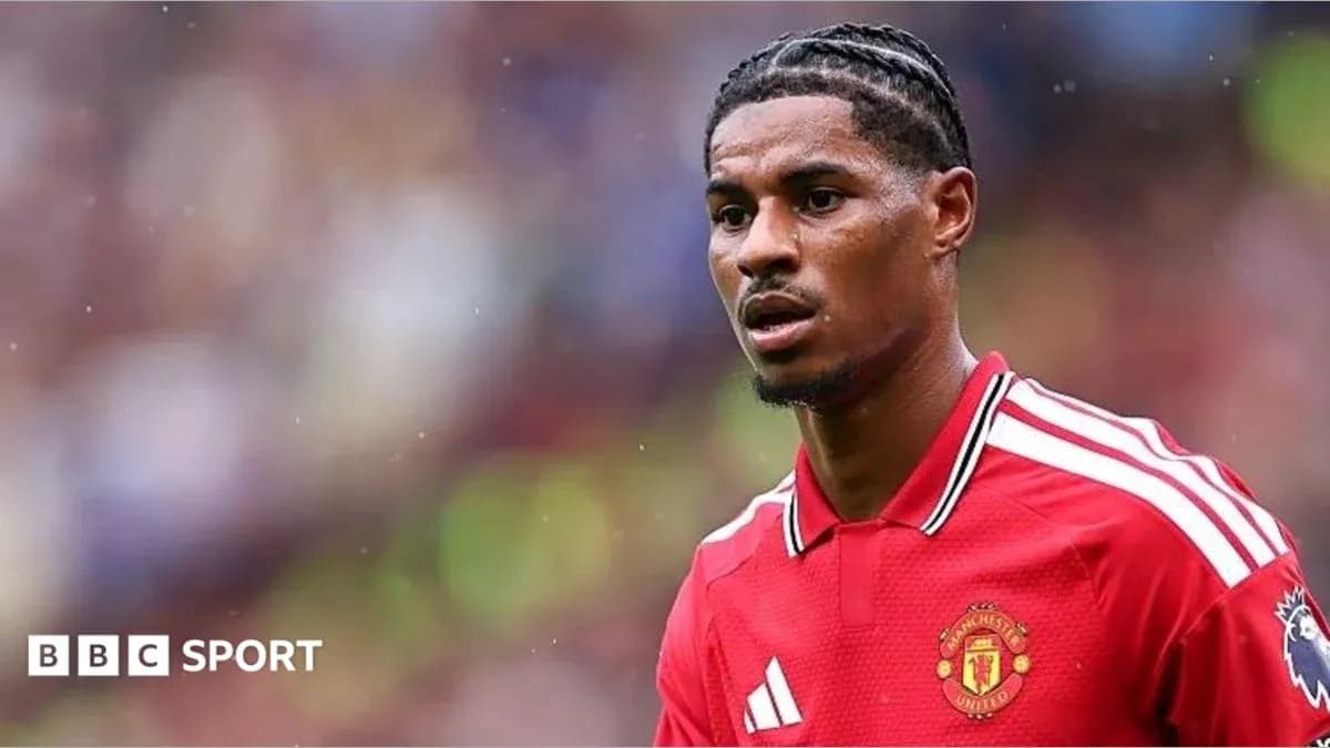 Player wearing Manchester United jersey on field Player wearing Manchester United jersey on field