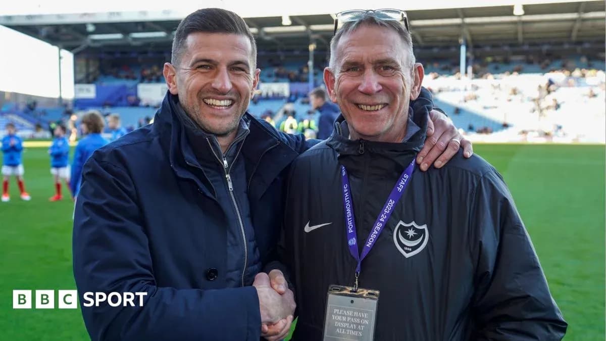 Two men smiling and shaking hands on field Two men smiling and shaking hands on field