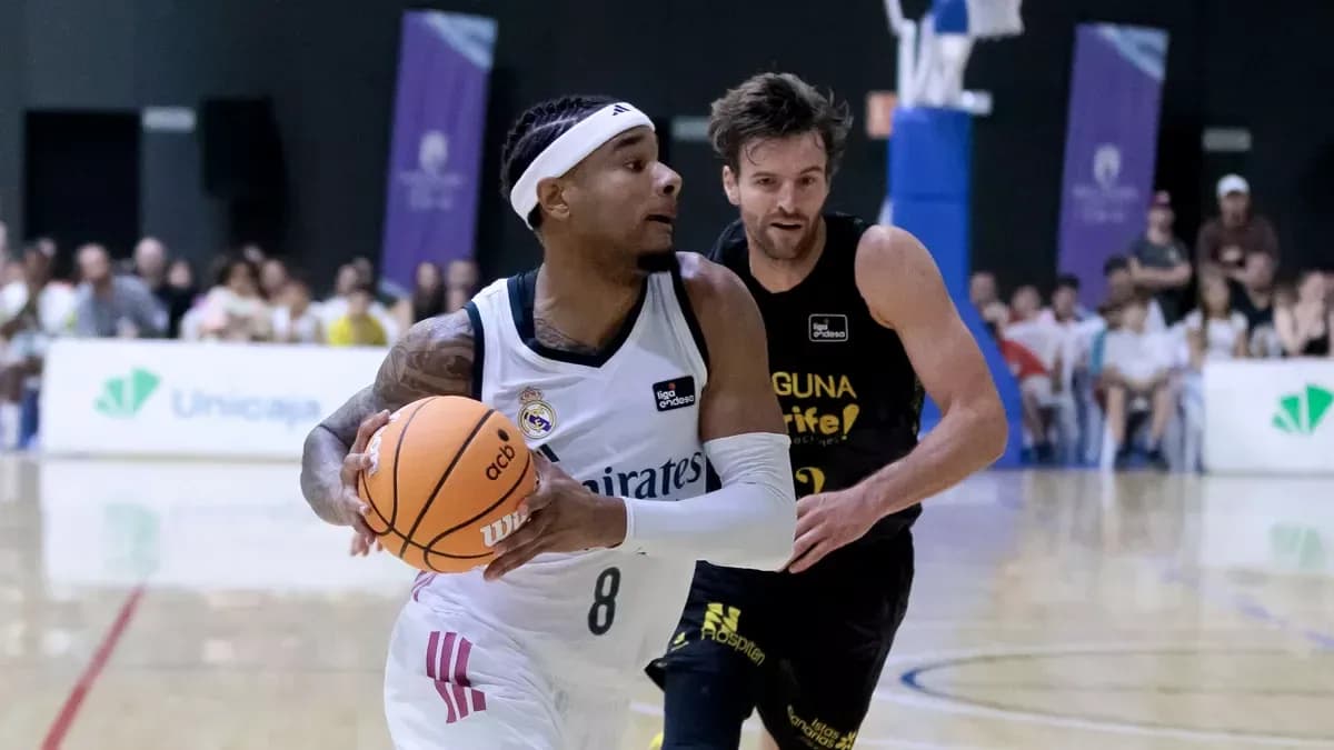 Player dribbling basketball with opponent in pursuit Player dribbling basketball with opponent in pursuit