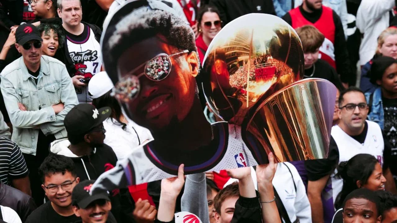 Fans holding giant cutout of player with trophy Fans holding giant cutout of player with trophy